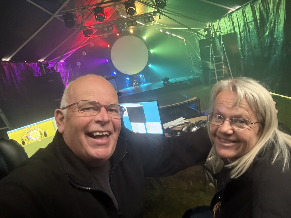 Phil and Kati at the production desk, with the lighting rig and circular screen behind them